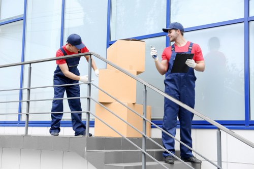 Professional movers carrying items from a Southwark apartment building