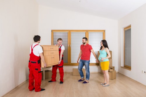 Professional movers protecting floors and doorways during transit