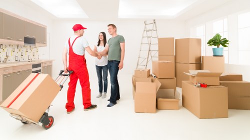 Removal crew unloading items at a Southwark property with careful access handling