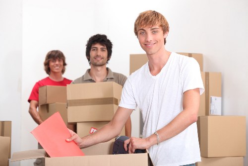 Staff coordinating a careful furniture move with clear communication
